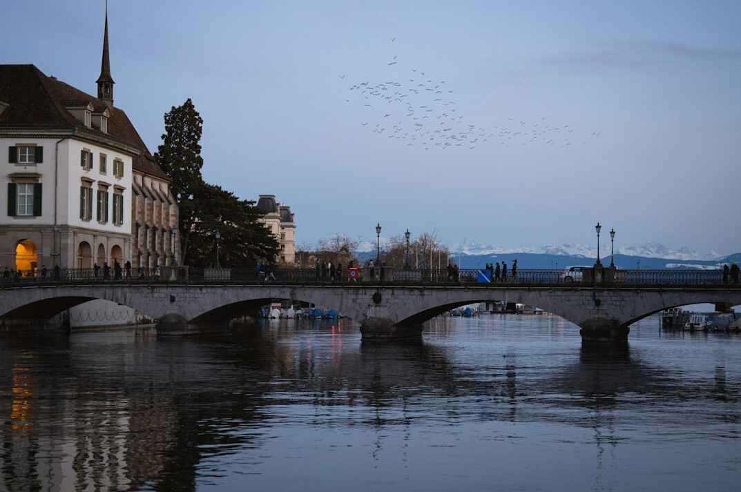 River promenade and bridge in a European city at twilight