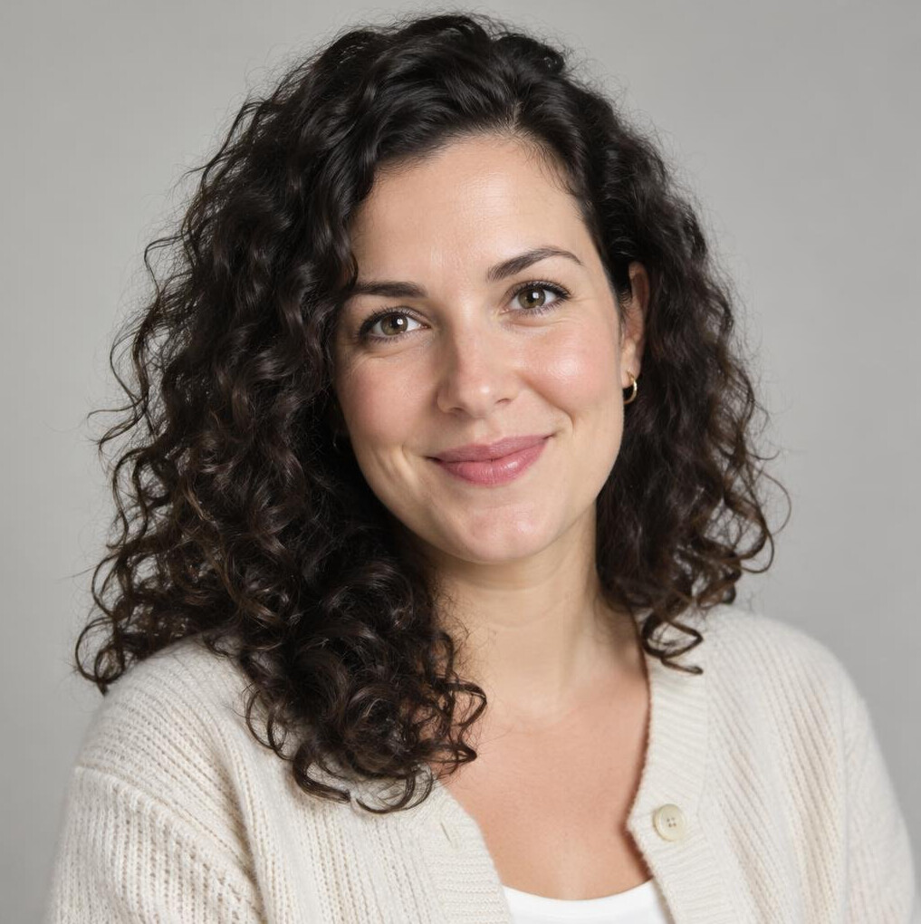 Portrait of a woman with curly hair in a light top