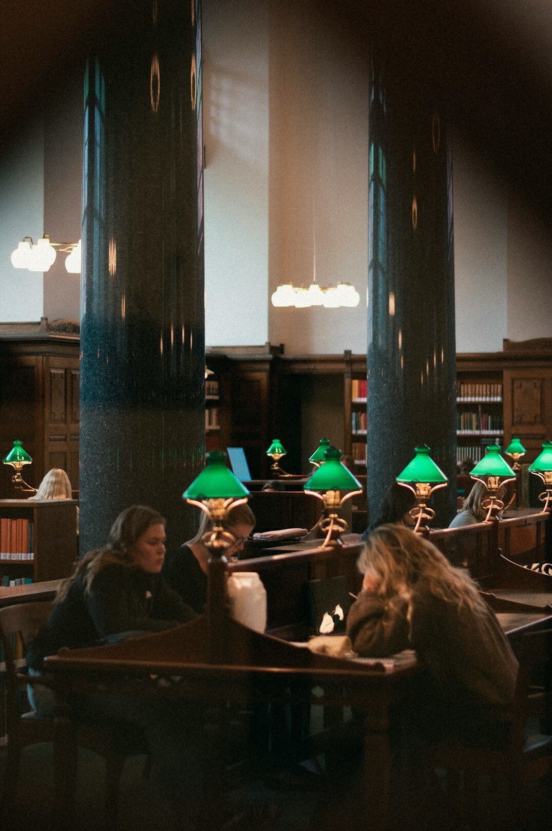 Grand library interior with reading tables and warm lamps
